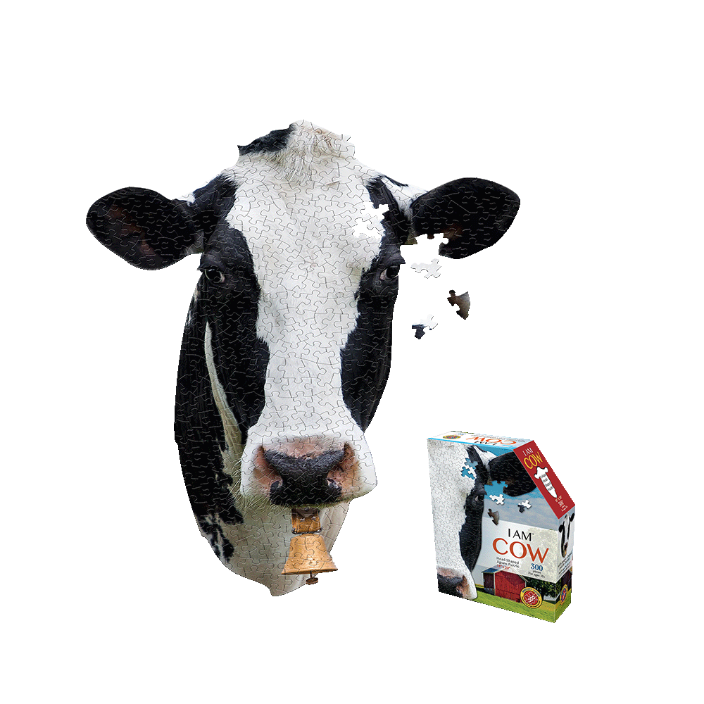 Black and white cow-shaped jigsaw puzzle with some pieces missing, shown next to I AM COW puzzle box packaging