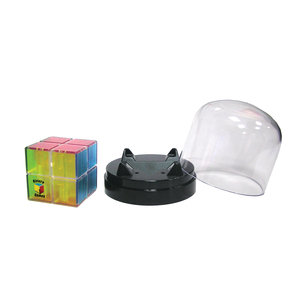 Colorful cube puzzle with pink, green, and blue sections next to black cat-shaped base and clear dome cover