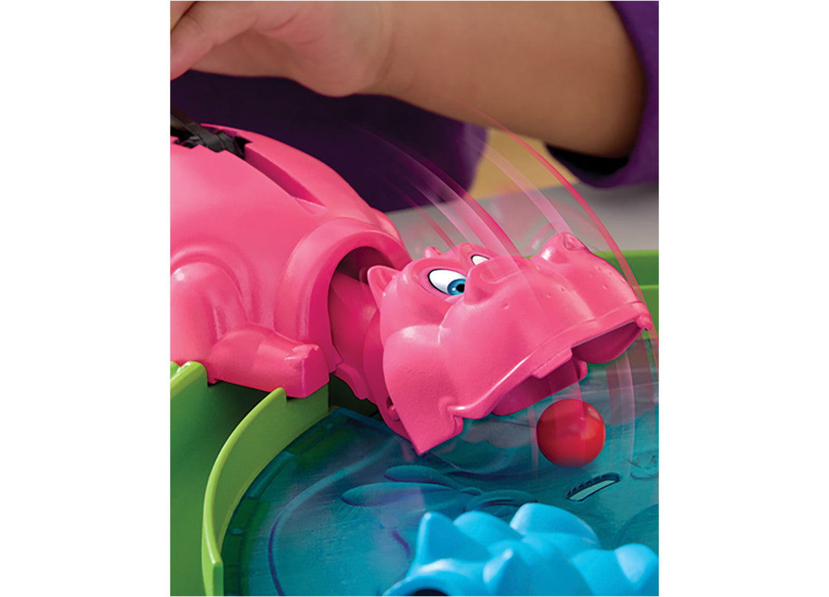 Hungry Hungry Hippos game with pink hippo figure and red marble on colorful board
