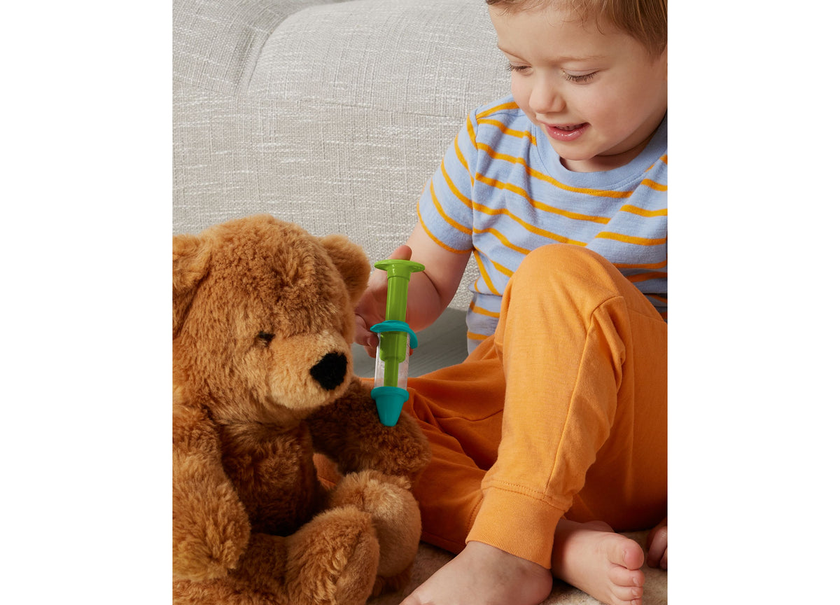 Fisher-Price Doctor Role Play Medical Kit with child demonstrating stethoscope on teddy bear