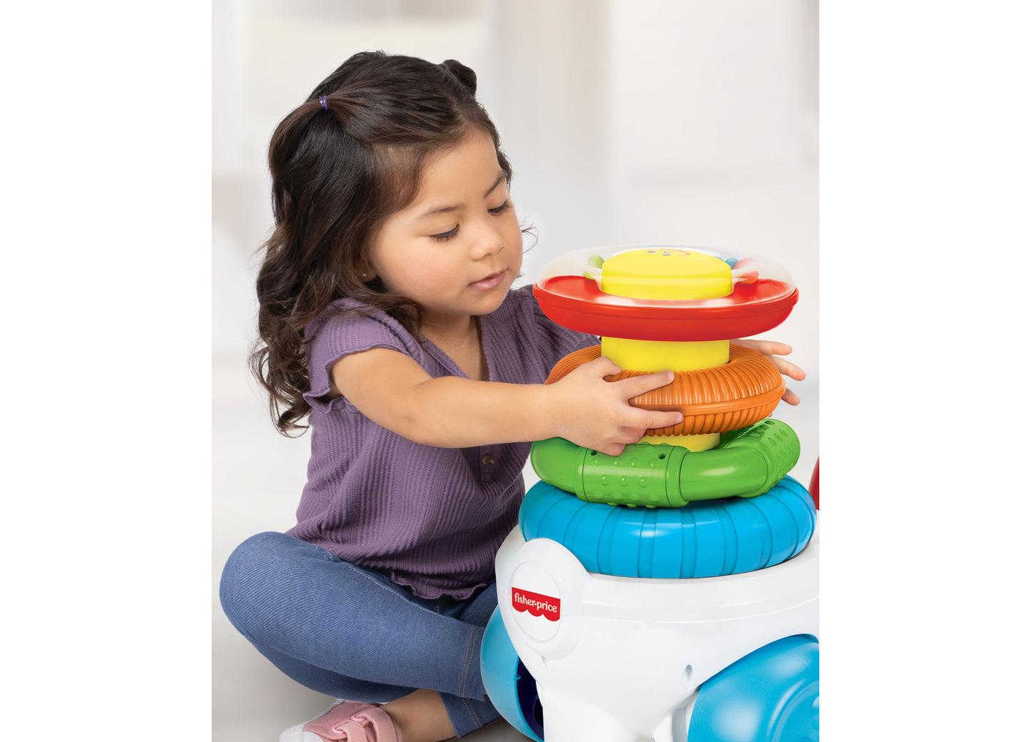 Fisher Price Rock a Stack Ride-On toy with colorful stacking rings in blue, green, orange, yellow, and red