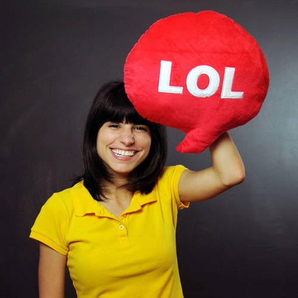 Child modeled by girl holding large red plush speech bubble pillow with white "LOL" text