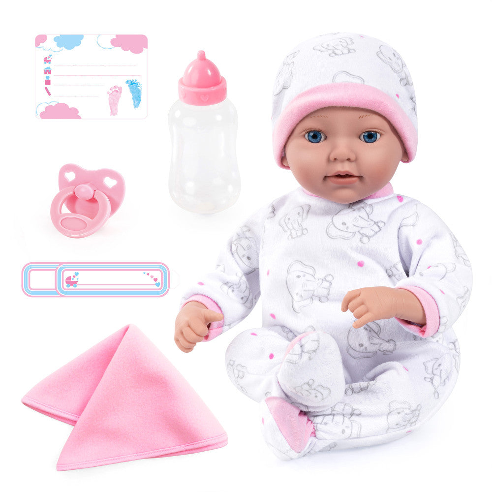 Baby doll with blue eyes wearing white pajamas with gray elephant print and pink hat, modeled by a child, surrounded by accessories including bottle, pacifier,