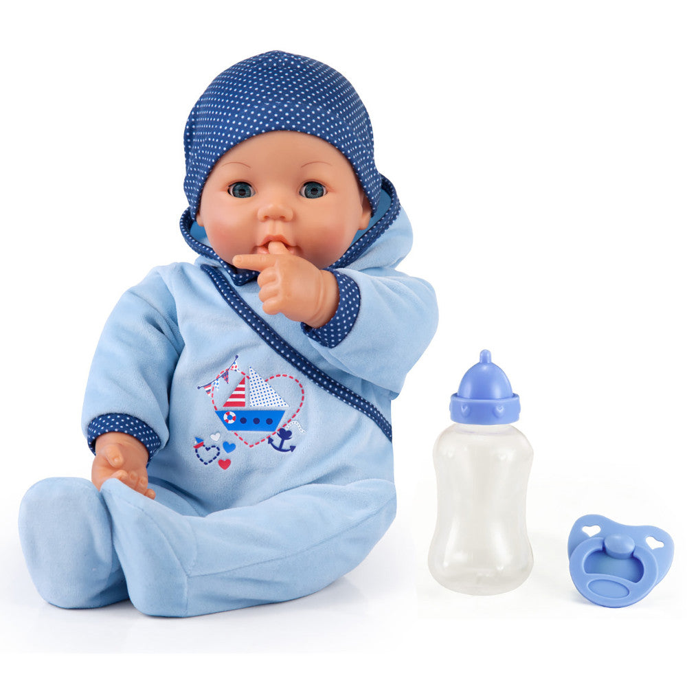 Baby doll with blue polka-dot bonnet and light blue romper featuring a sailboat design, with finger in mouth, shown with included bottle and pacifier accessorie