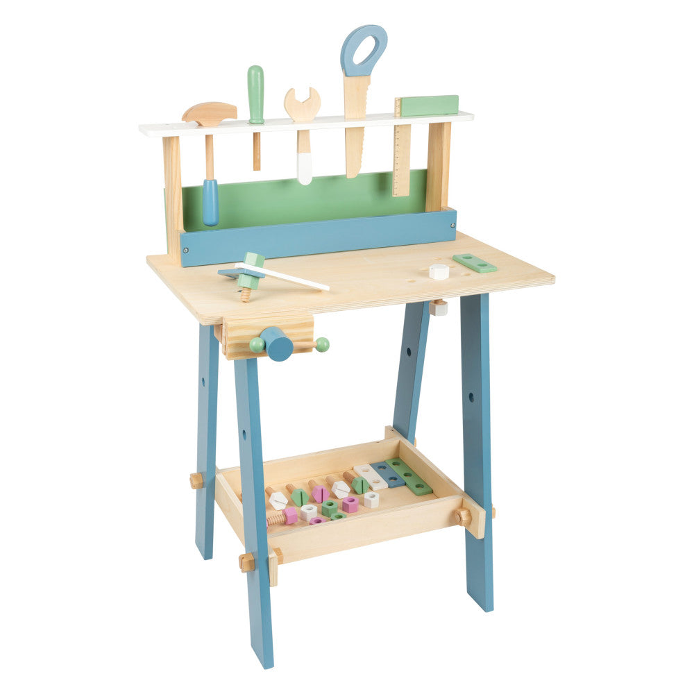 Wooden workbench with natural pine top, blue legs, and green tool storage panel. Includes toy tools like saw, wrench, and screwdriver on top shelf, vise on side