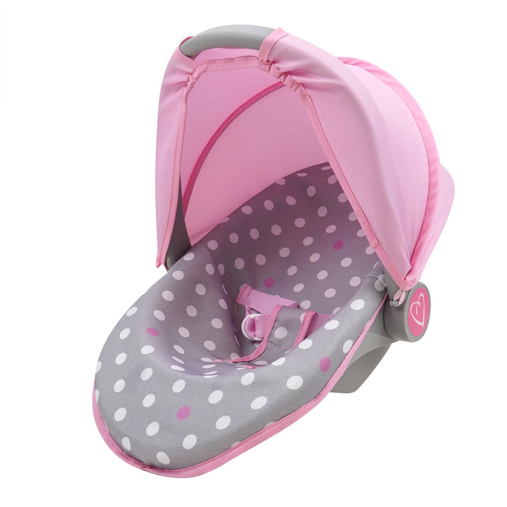 Pink and grey polka dot doll car seat with canopy, featuring white and pink dots on grey interior, pink fabric hood, and grey handles
