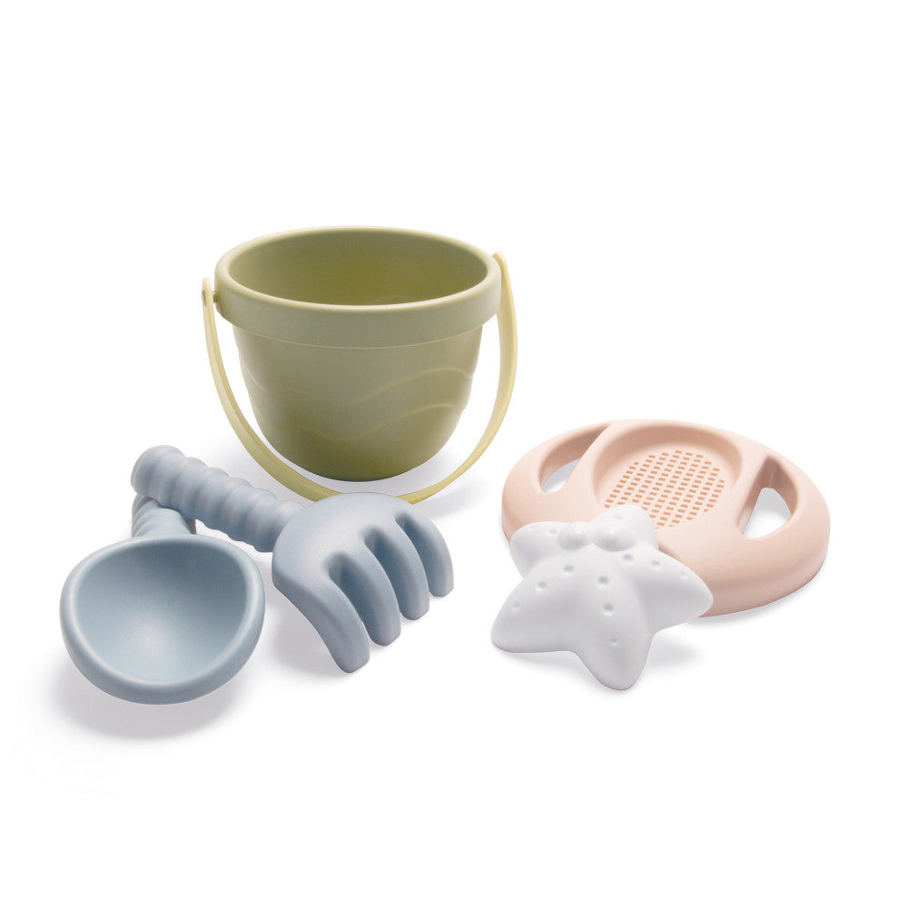 Dantoy Tiny BIO Bucket Playset with pale green bucket, blue scoop, gray rake and hand tools, pink sifter, and white starfish toy on plain background