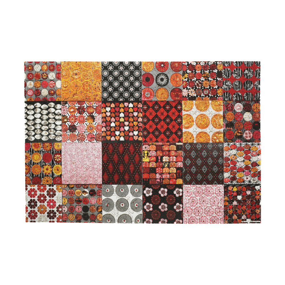 Wooden jigsaw puzzle box lid showing grid of 24 fabric swatch patterns in red, orange, yellow, pink, black, and cream with floral and geometric designs