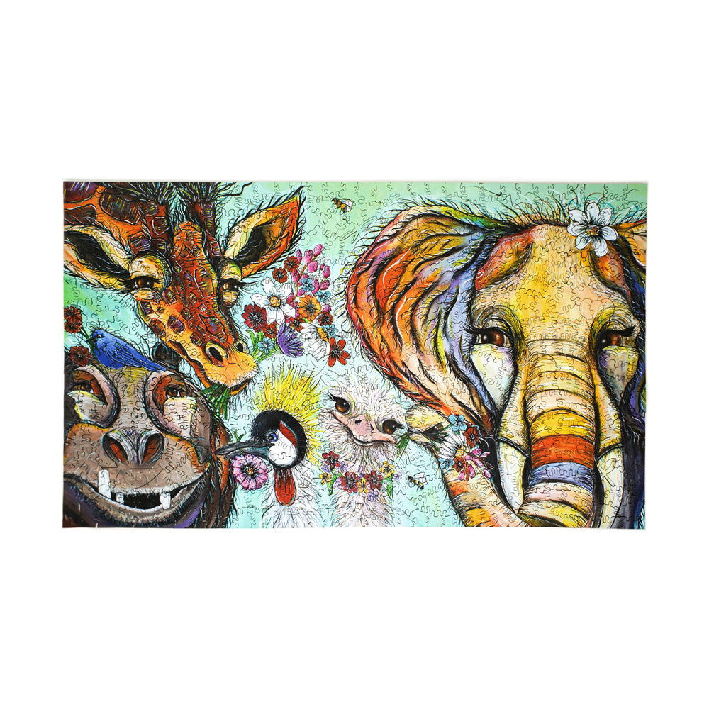 Tropical Jungle Wooden Jigsaw Puzzle box image showing colorful illustrated giraffe, elephant, and hippo with vibrant florals and wildlife on mint green backgro