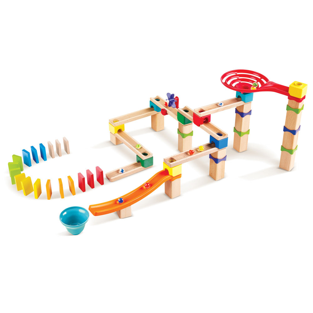 Hape Marble Run wooden building set with natural wood tracks, colorful ramps, towers, dominoes, and a blue catch cup on plain background