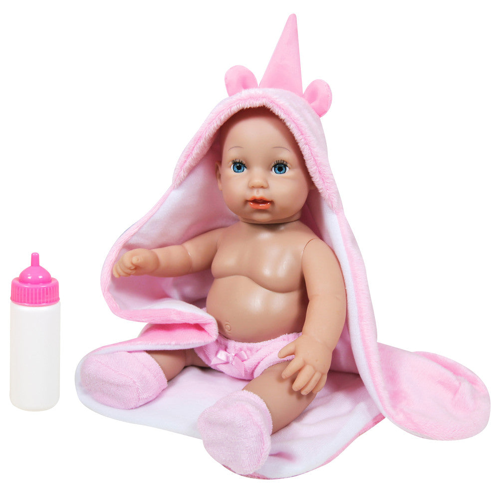 Baby doll with blue eyes and rooted hair wearing pink unicorn hood with pointed horn and ears, includes white bottle with pink cap and pink socks