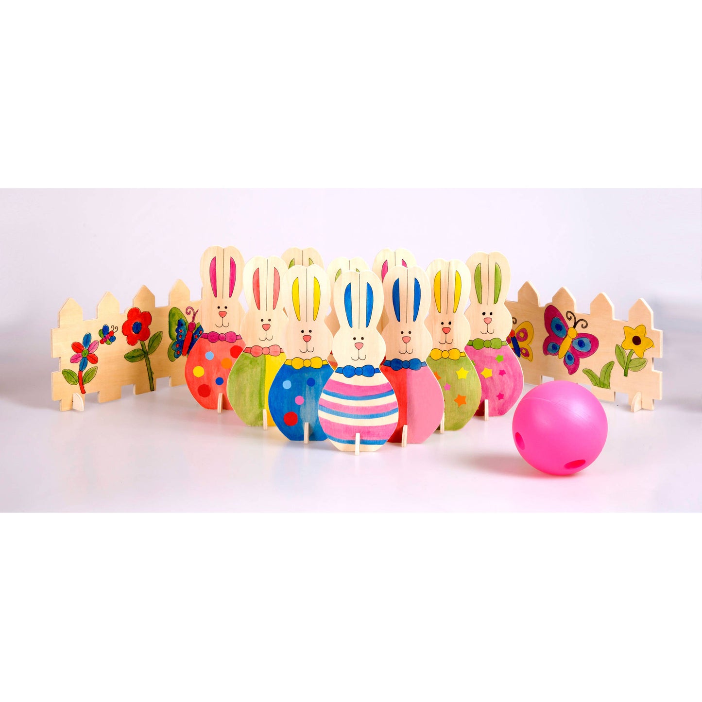 Wooden bowling set with colorful painted bunny pins and flower-decorated pins, pink bowling ball, on plain background