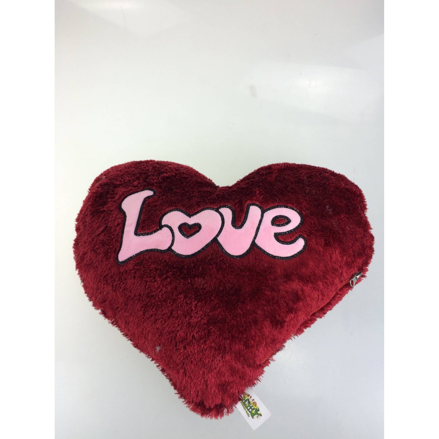 Red plush heart pillow with pink "Love" text and small heart detail
