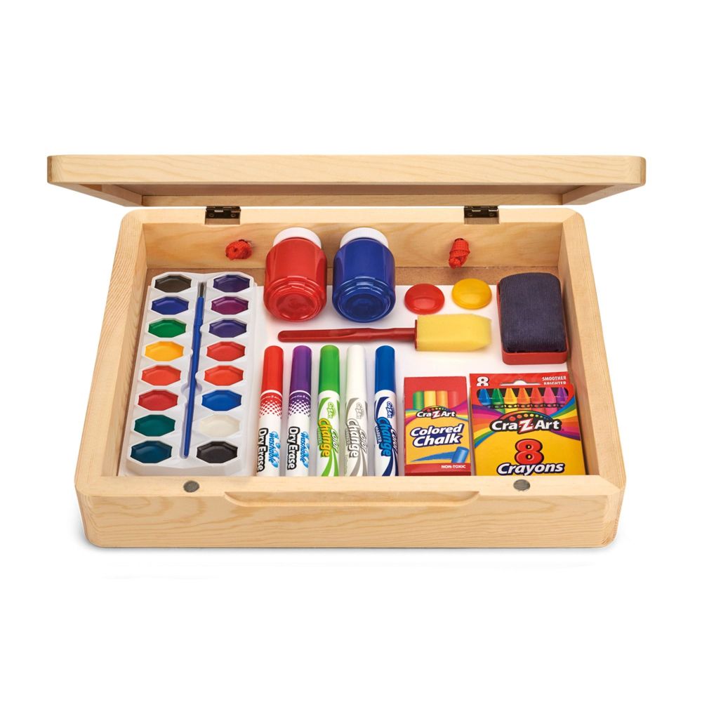 Wooden art supply storage box with hinged lid, open to reveal organized compartments containing paint palettes, markers, crayons, colored pencils, paintbrushes,