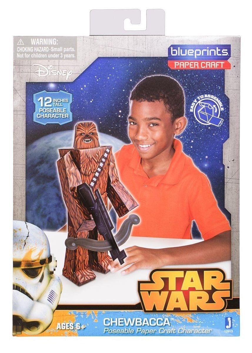 Star Wars Blueprints Paper Craft Chewbacca 12-inch poseable character, modeled by a child in orange shirt holding the paper craft figure with blaster rifle