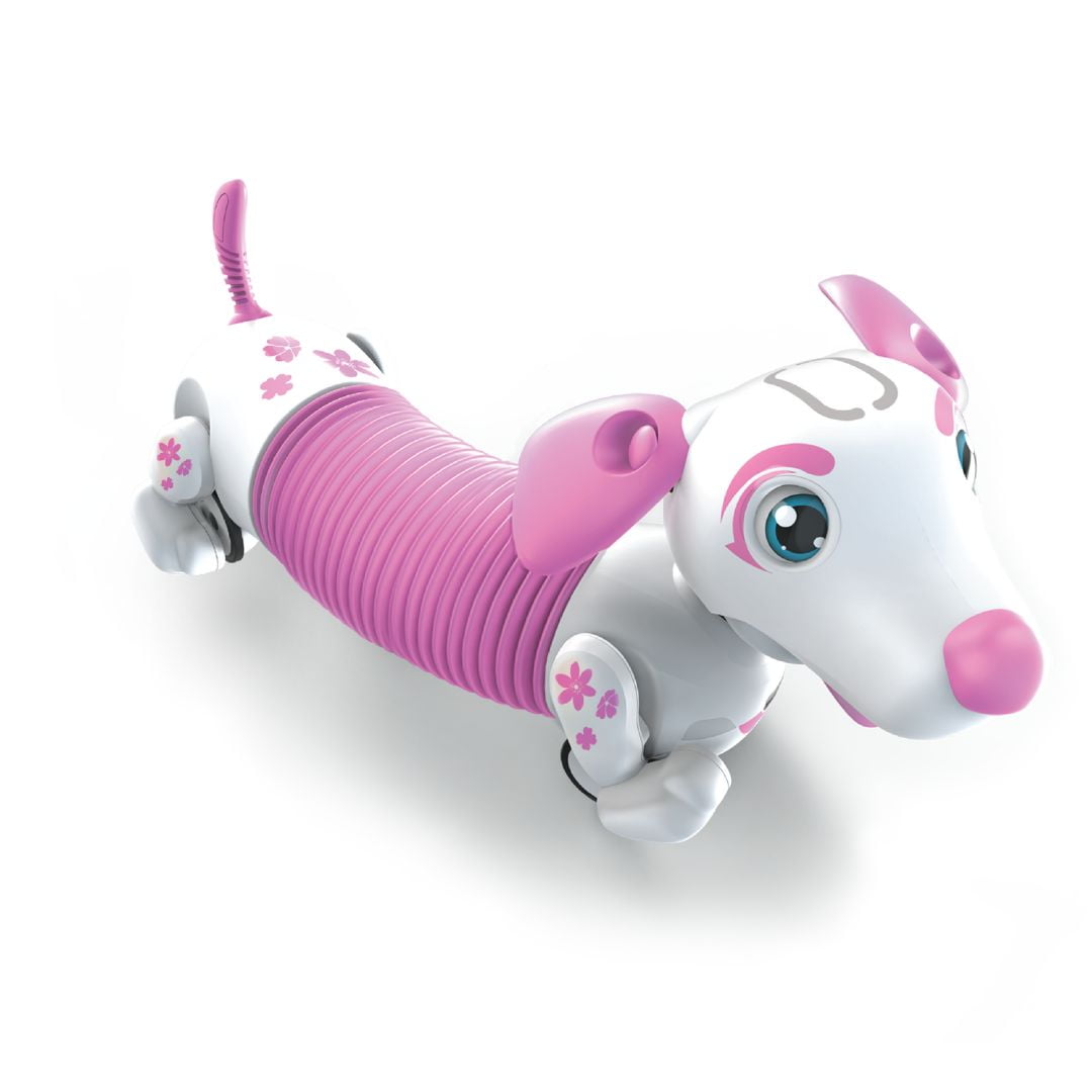 White and pink interactive robotic puppy with ribbed magenta midsection, large blue eyes, flower details, and articulated limbs on plain background