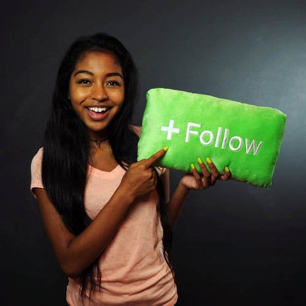 Modeled by a child holding bright green '+Follow' button pillow against dark background