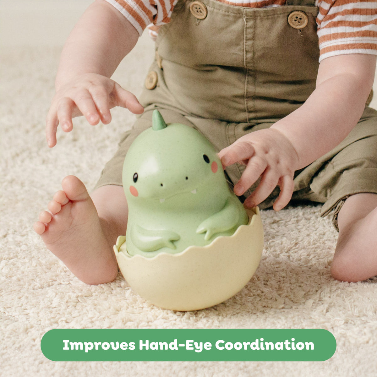 Tiger Tribe Roly Poly Dino green eco toy with baby hands, develops motor skills