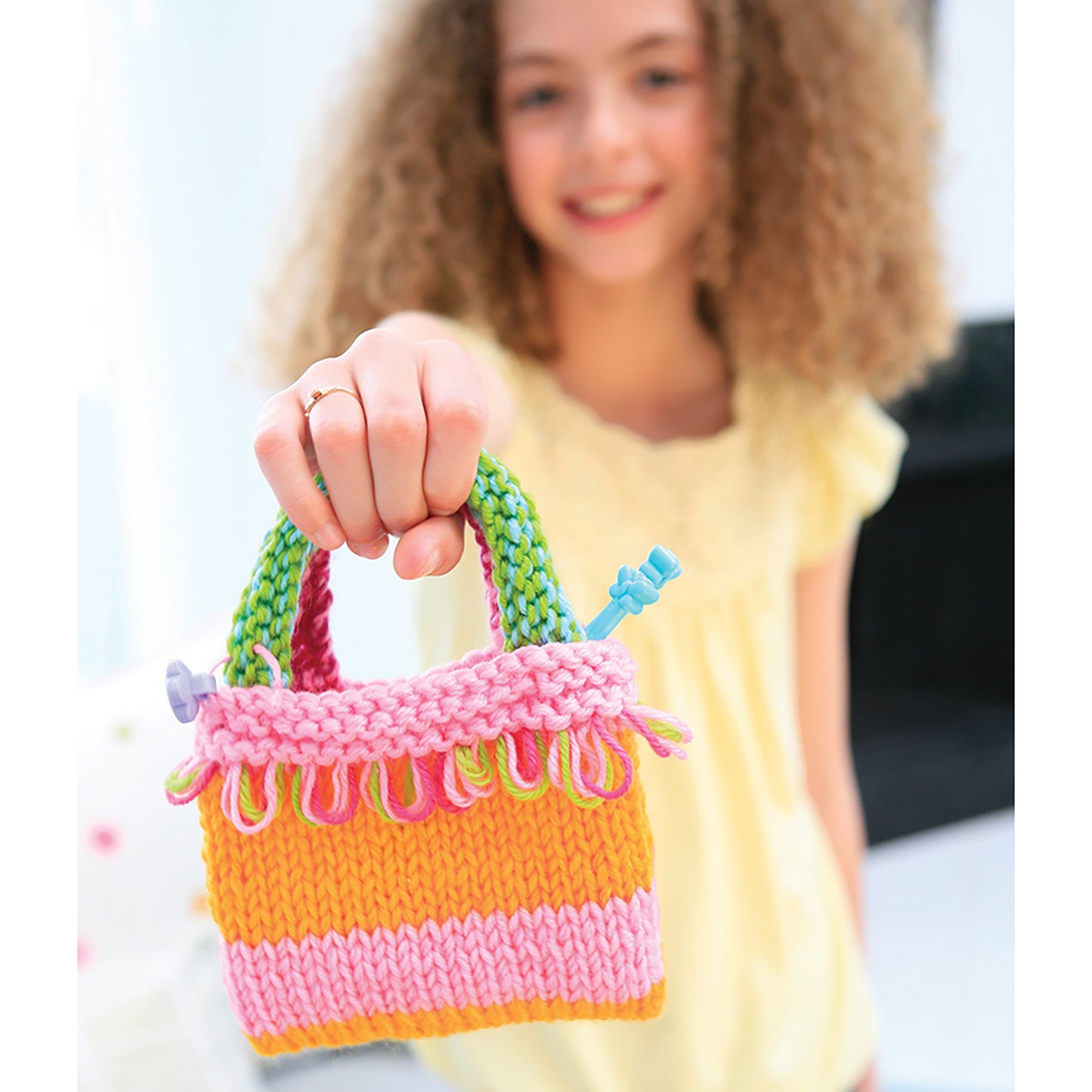 Easy-To-Do Knitting colorful knitted bag craft toy in pink, orange, and yellow