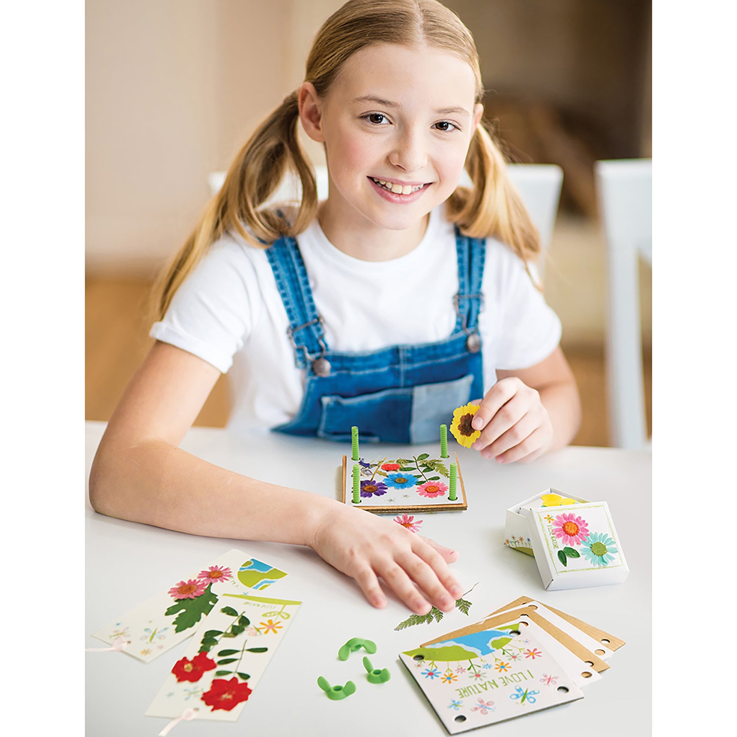 Girl playing with Green Creativity Pressed Flower Art craft kit with colorful dried flowers