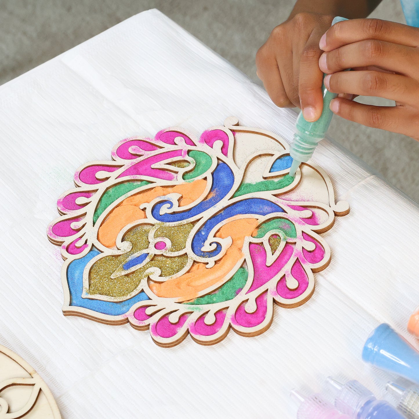Make Your Own Wooden Rangoli craft kit with colorful painted pieces in pink, blue, green, and gold