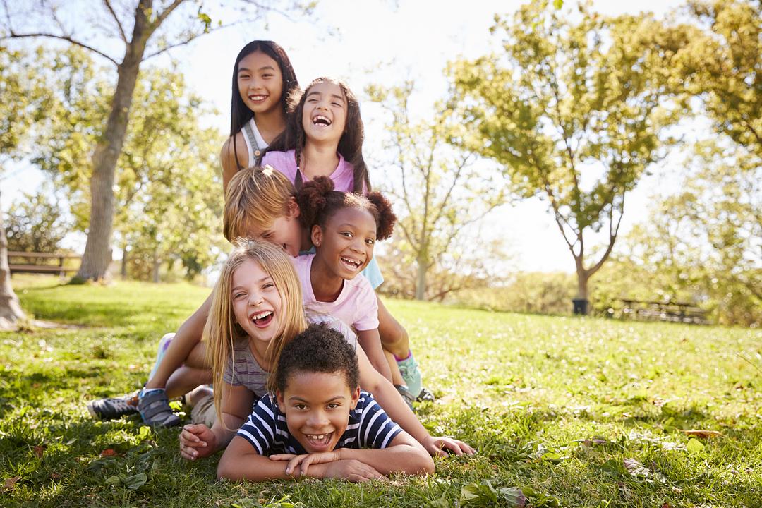 Kids piled up having fun outside