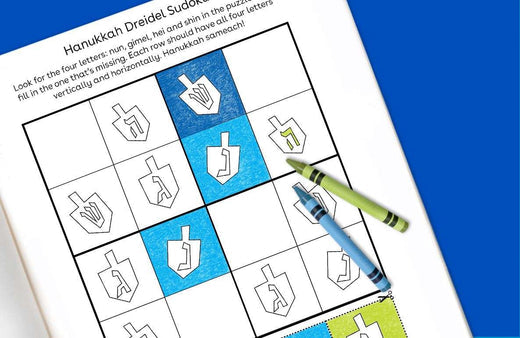 Hanukkah Dreidel Sudoku printable puzzle with dreidel symbols in a grid, blue and white colored squares, and a pencil on a blue background