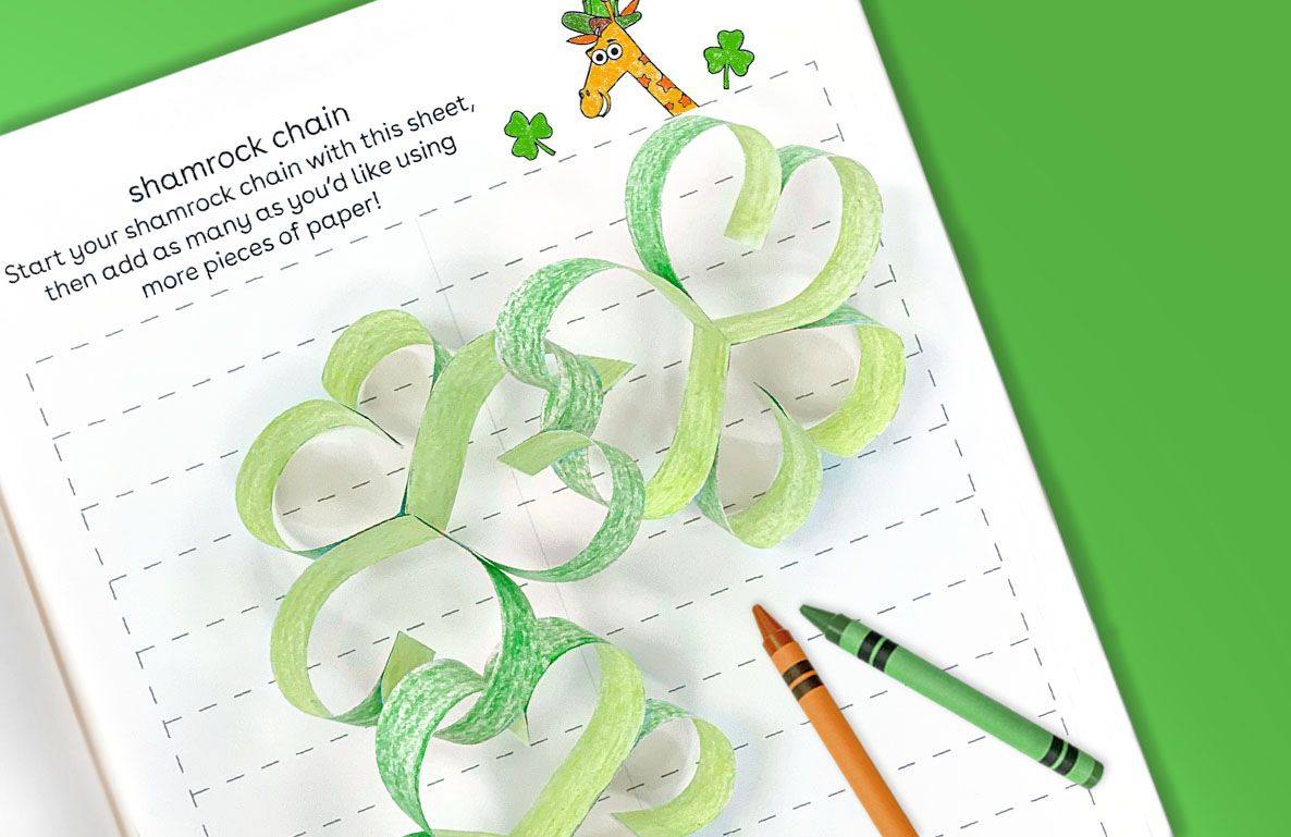 Shamrock chain craft project made from green paper strips linked together, with instruction text and illustrated giraffe and clover designs at top of page, oran