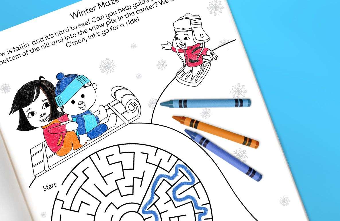 Winter Maze printable activity page with illustrated children sledding, snowman, and maze puzzle with crayons on blue background