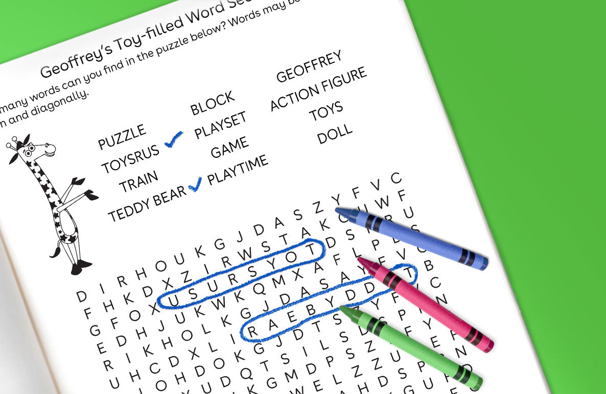 Geoffrey's Toy-filled Word Search puzzle page with giraffe mascot, word list including puzzle, toys, block playset, action figure, doll, train, teddy bear, and
