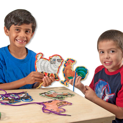 Lace & Trace Farm Wooden Lacing Set with colorful animal panels being used by two children