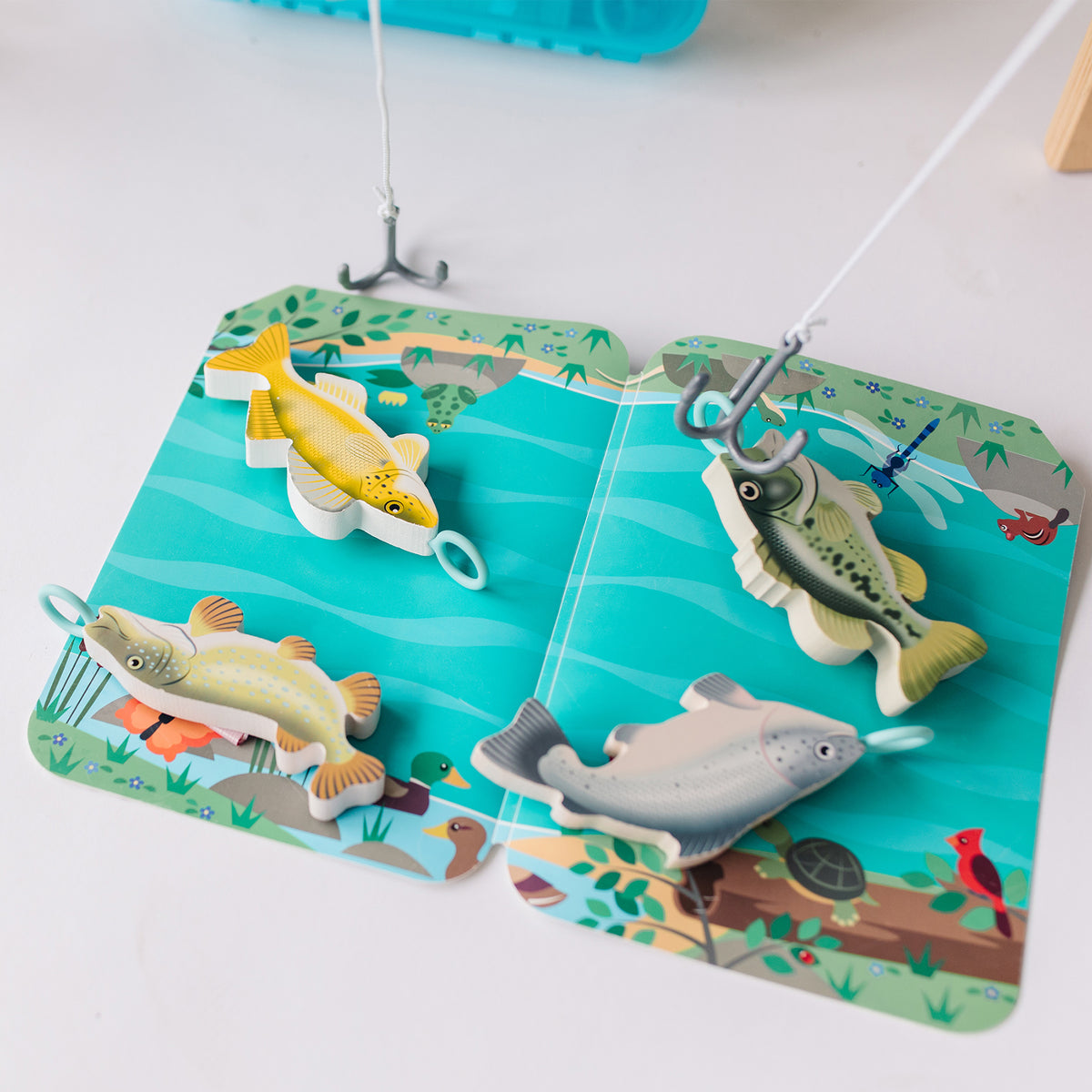 Melissa & Doug Fishing Play Set with colorful fish toys and magnetic fishing rods on water scene mat