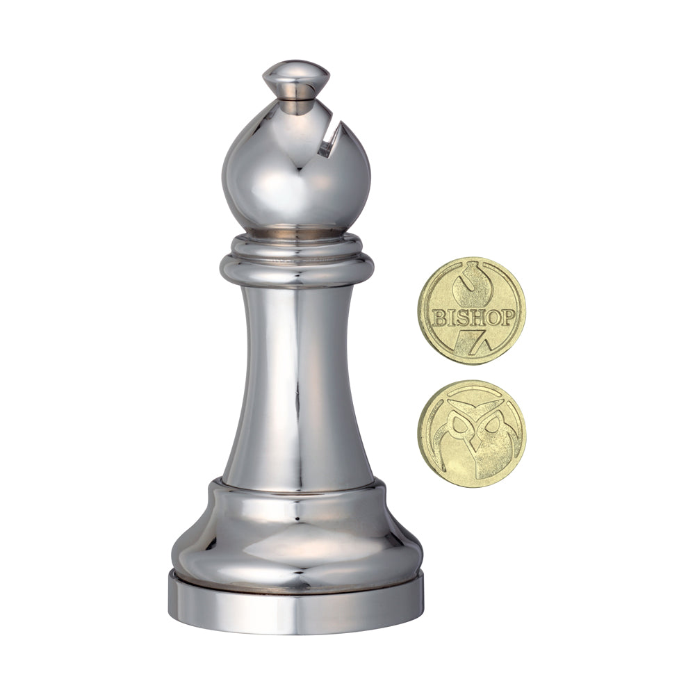 Silver metal chess bishop puzzle piece shown next to two gold coins for scale