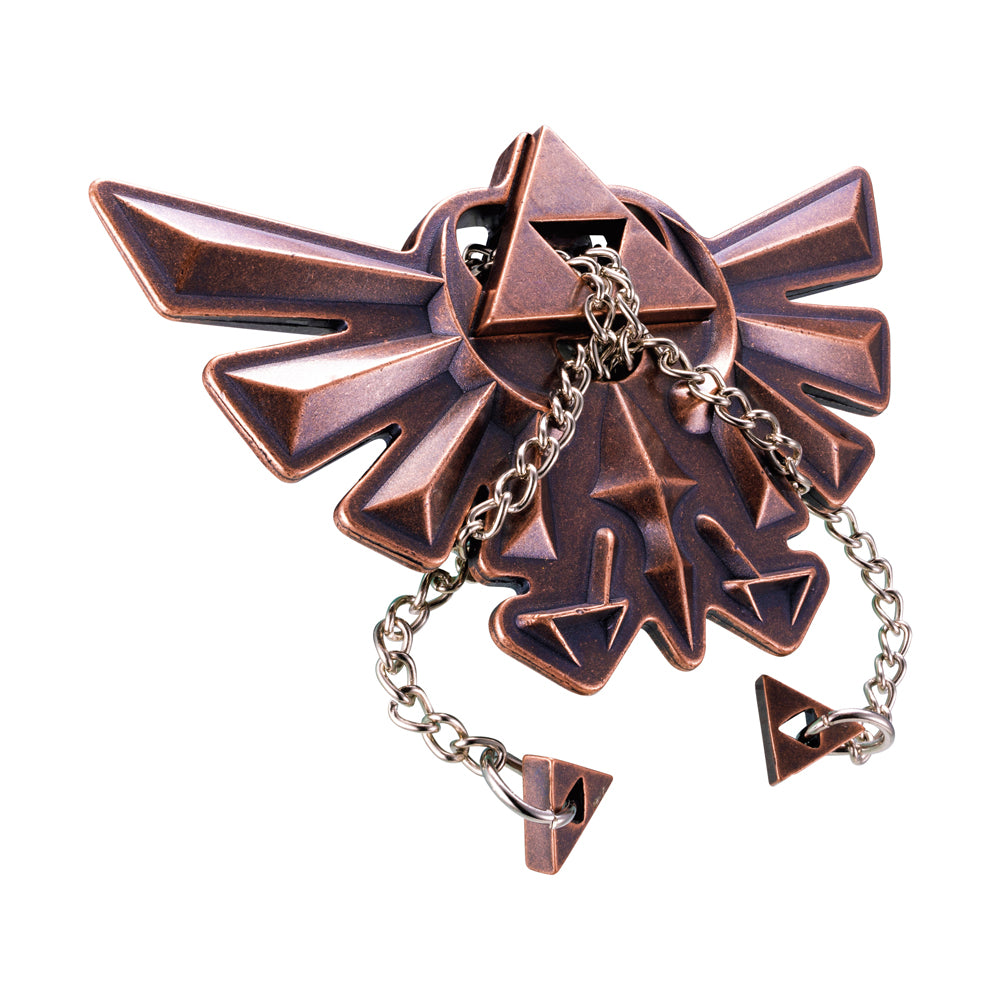 Copper-colored metal puzzle shaped like the Hyrule Crest from The Legend of Zelda, with interlocking geometric pieces and dangling chain links