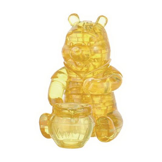 Golden translucent 3D crystal puzzle of Winnie the Pooh holding a honey pot, assembled on plain background