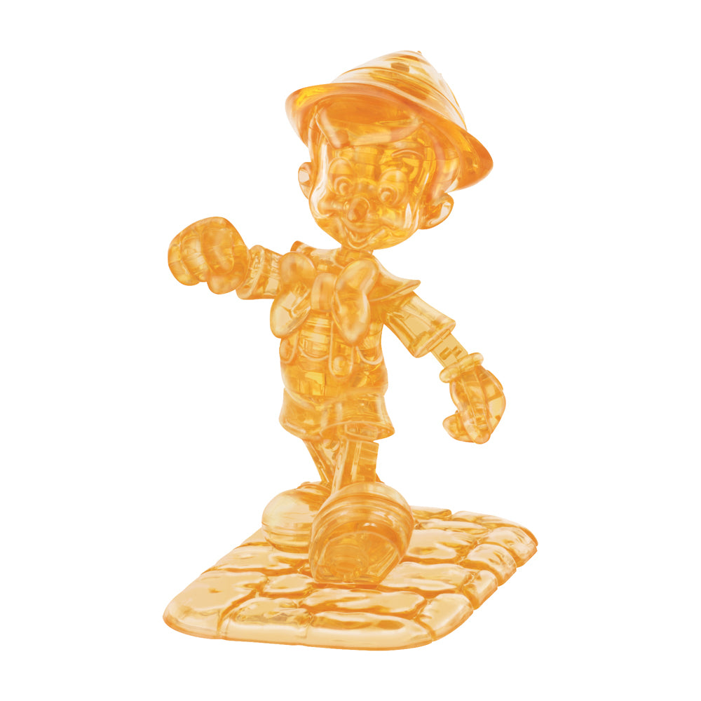 Translucent amber 3D crystal puzzle figure of Pinocchio wearing a hat and outfit, standing on a geometric base