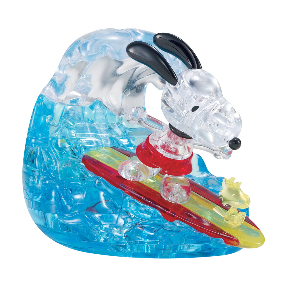 BePuzzled Peanuts Snoopy Surf 3D Crystal Puzzle with 41 transparent blue, clear, red, and yellow interlocking plastic pieces forming Snoopy character on a surfb