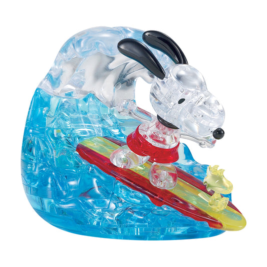 BePuzzled Peanuts Snoopy Surf 3D Crystal Puzzle with 41 transparent blue, clear, red, and yellow interlocking plastic pieces forming Snoopy character on a surfb