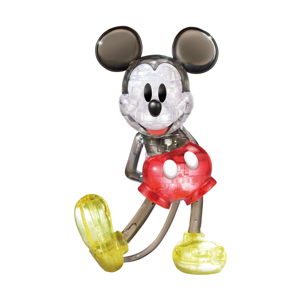 BePuzzled Disney Mickey Mouse 3D Crystal Puzzle, transparent Mickey figure with black ears, white face, red shorts, and yellow shoes on plain background