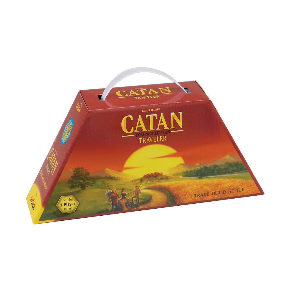 Catan Traveler Compact Edition board game box with carrying handle, red trapezoid-shaped packaging featuring a sunset landscape and game title