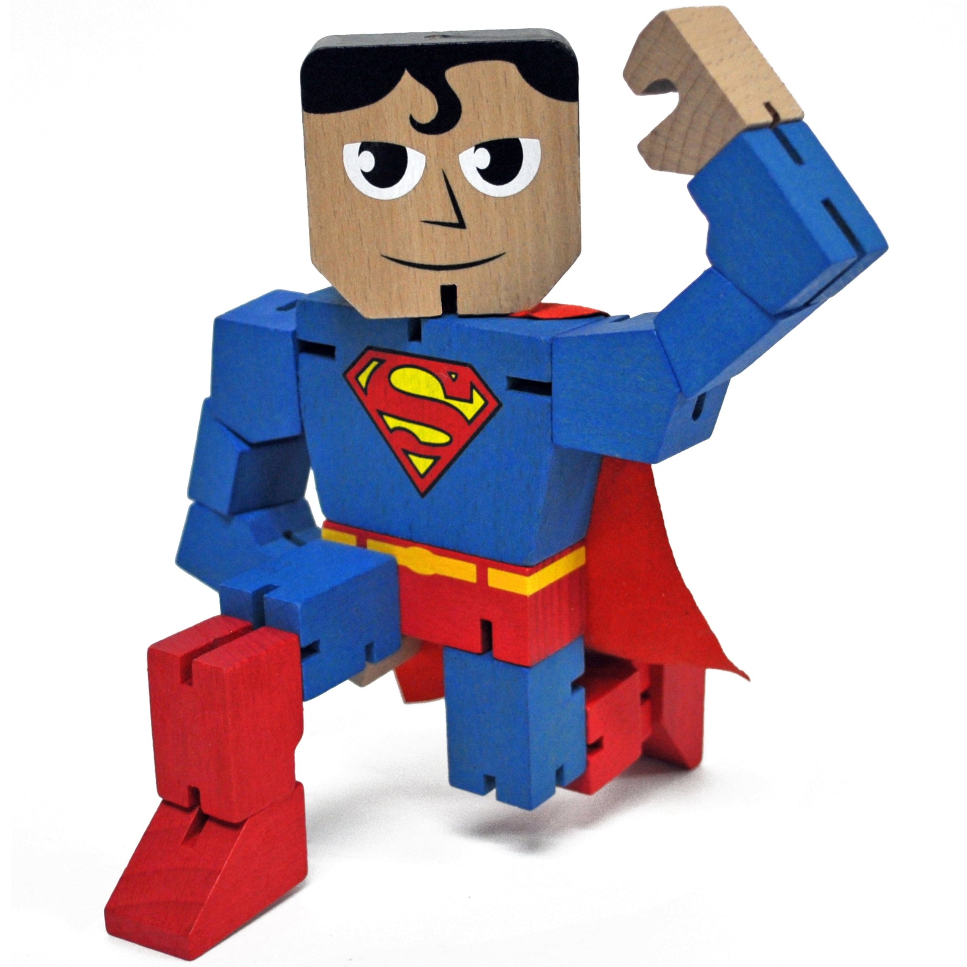 Wooden block Superman action figure with blue suit, red cape, and S-shield logo, posing with fist raised