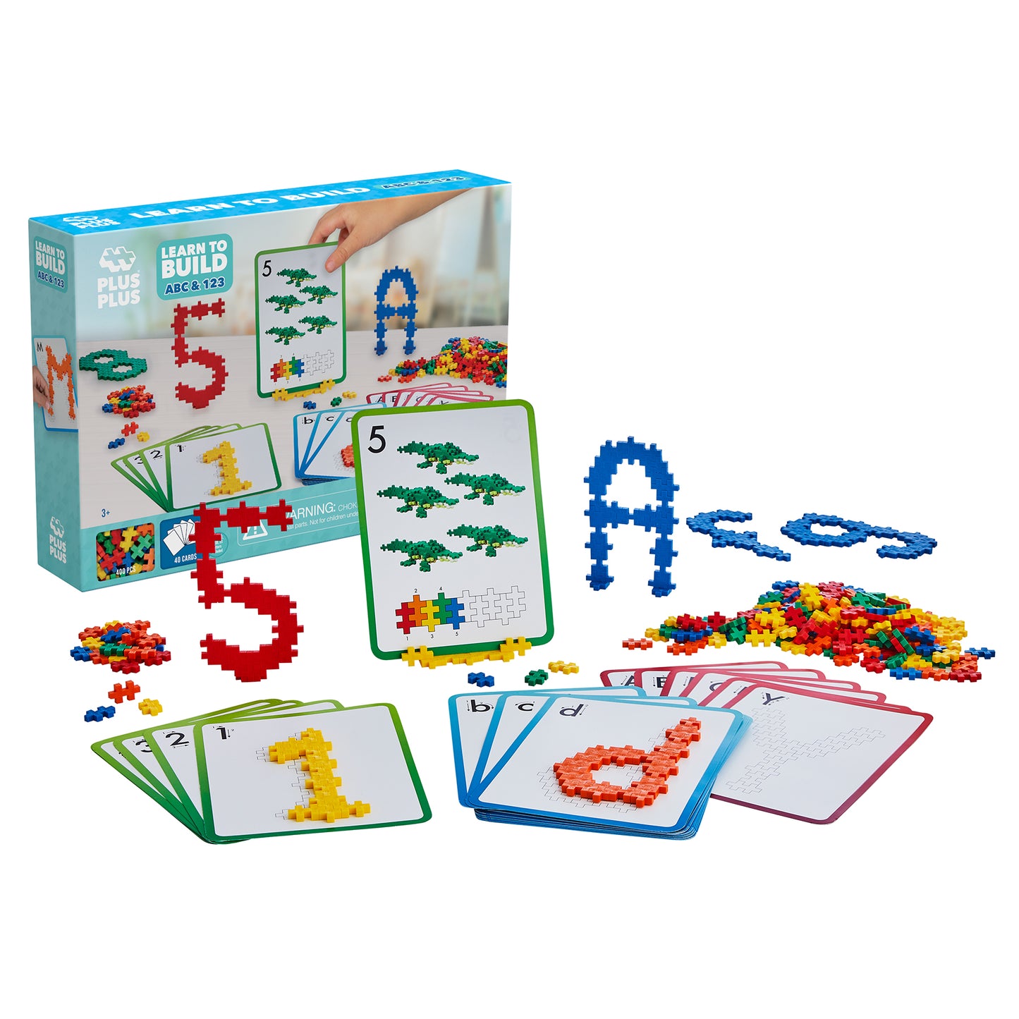 Plus-Plus Learn to Build Set with colorful plastic building blocks, instruction cards showing numbers and letters, and assembled block shapes including the numb