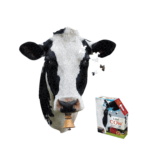 Black and white cow-shaped jigsaw puzzle with some pieces missing, shown next to I AM COW puzzle box packaging