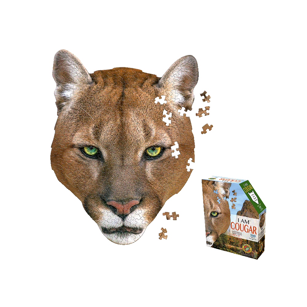 Madd Capp I AM COUGAR Jigsaw Puzzle showing cougar head-shaped puzzle with green eyes and scattered pieces, with product box displayed on right