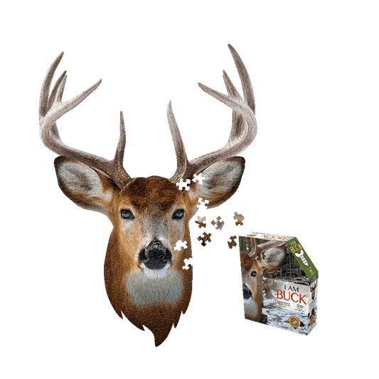 Madd Capp I AM BUCK Jigsaw Puzzle 300 pc showing completed puzzle image of buck deer head with antlers and puzzle pieces scattered, with product box displayed