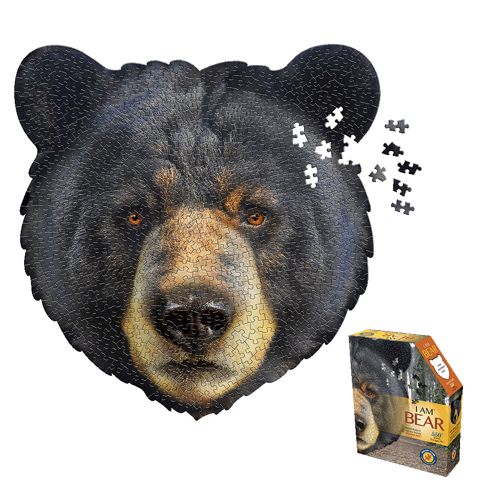 Bear-shaped jigsaw puzzle with black fur and tan face showing assembled puzzle with loose pieces scattered, displayed with product box