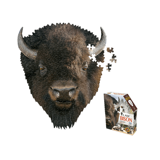 Madd Capp I AM BISON 300-piece jigsaw puzzle shaped like a bison head with horns, shown assembled and partially assembled with loose pieces, alongside product b