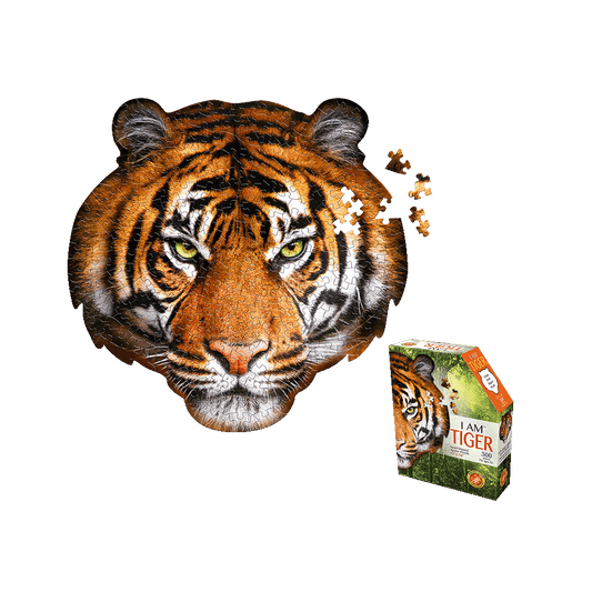 Tiger face-shaped jigsaw puzzle with yellow eyes and black stripes on orange, shown assembled with loose pieces, next to product box labeled 'I AM TIGER 300 pc'