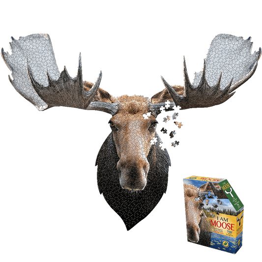 Moose head-shaped 700-piece jigsaw puzzle with assembled moose head showing puzzle pieces and box displaying I AM MOOSE branding