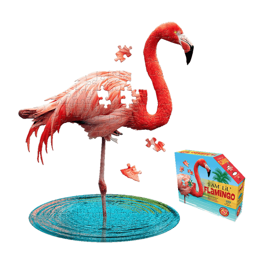 Assembled red flamingo-shaped jigsaw puzzle standing on turquoise base with loose pieces nearby, displayed next to product box